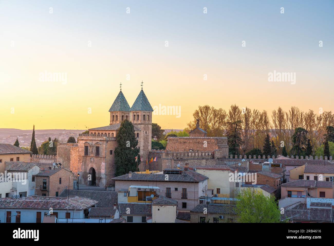 Toledo Skyline at sunset with Puerta de Bisagra Nueva Gate - Toledo, Spain Stock Photo