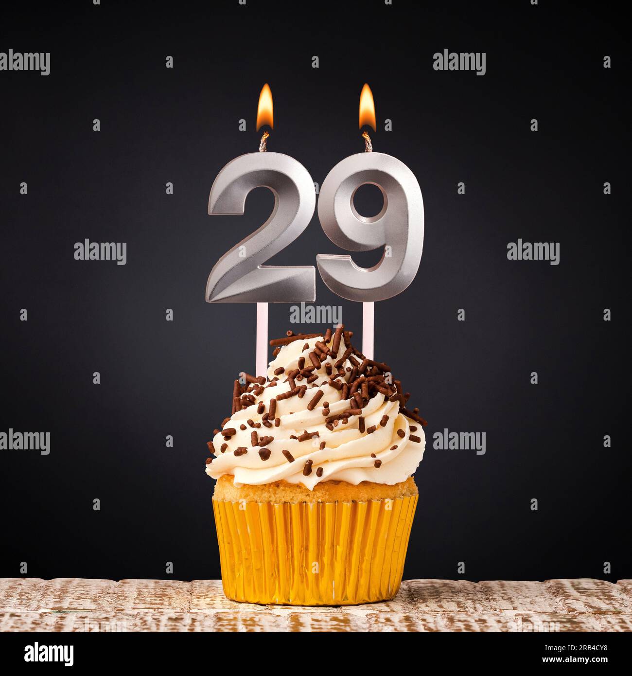 Birthday candle number 29 - Anniversary cupcake on black background Stock Photo