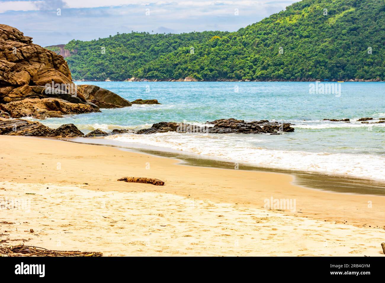 The sea between the beach, rocks and fully preserved rainforest in Trindade, Paraty district in Rio de Janeiro Stock Photo