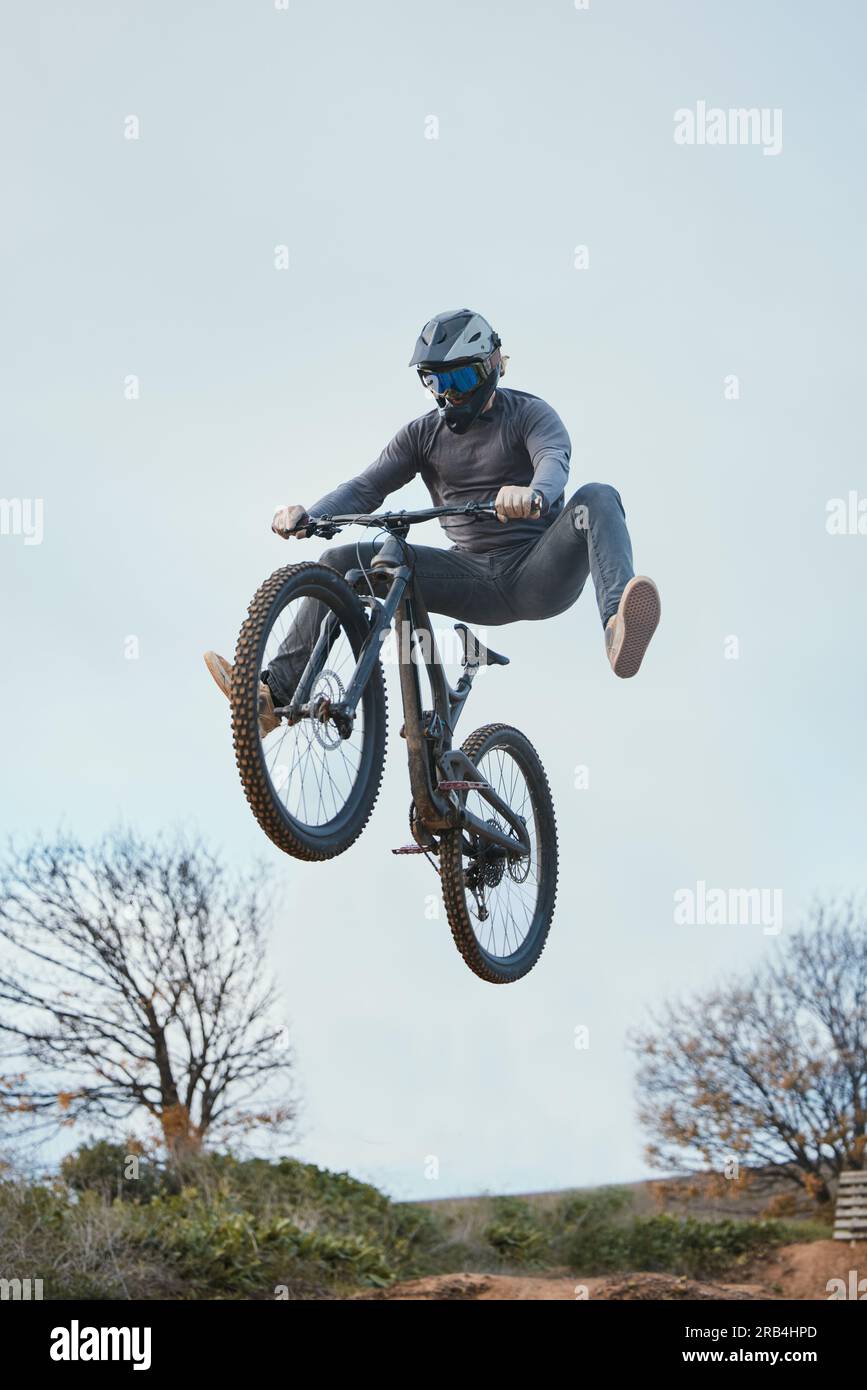 Mountain bike jump and person cycling on bicycle for extreme sports competition stunt or training in nature. Skill contest and professional athlete Stock Photo Alamy