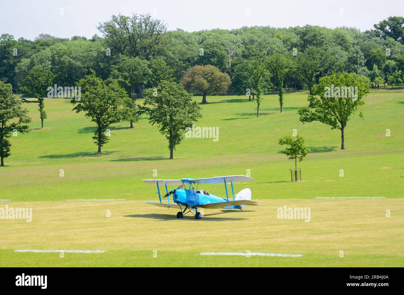 Tiger Moth plane taxiing on grass airstrip at wings & wheels event in