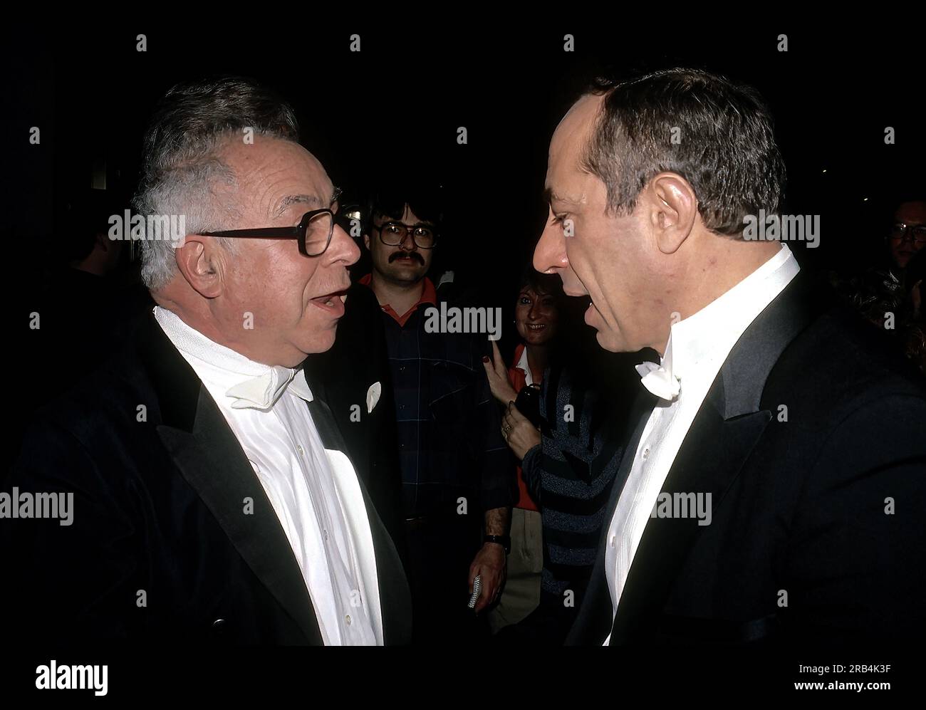 WASHINGTON DC - MARCH 26, 1988 Art Buchwald and New York Governor Mario Cuono stop to chat as they attend the White Tie Gridiron Club dinner at the Capitol Hilton hotel. Stock Photo