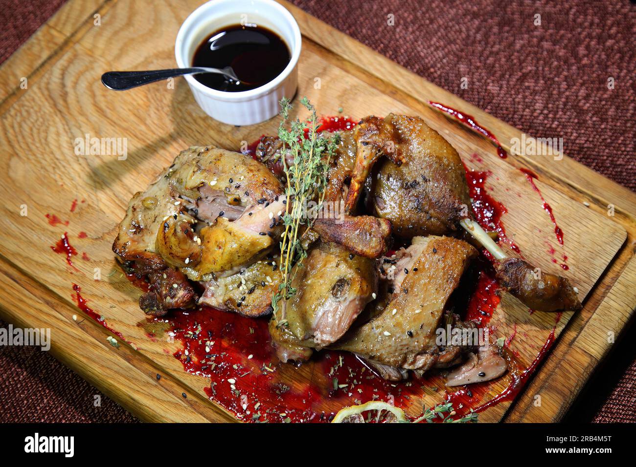 Duck leg. Baked duck leg with cherry sauce. Stock Photo