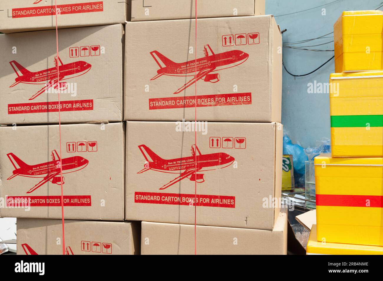 Ho Chi Minh City, Vietnam - May 22, 2023: Stacks of cardboard and styrofoam boxes with an airplane image prepared for shipping by air. Many parcels st - Stock Image