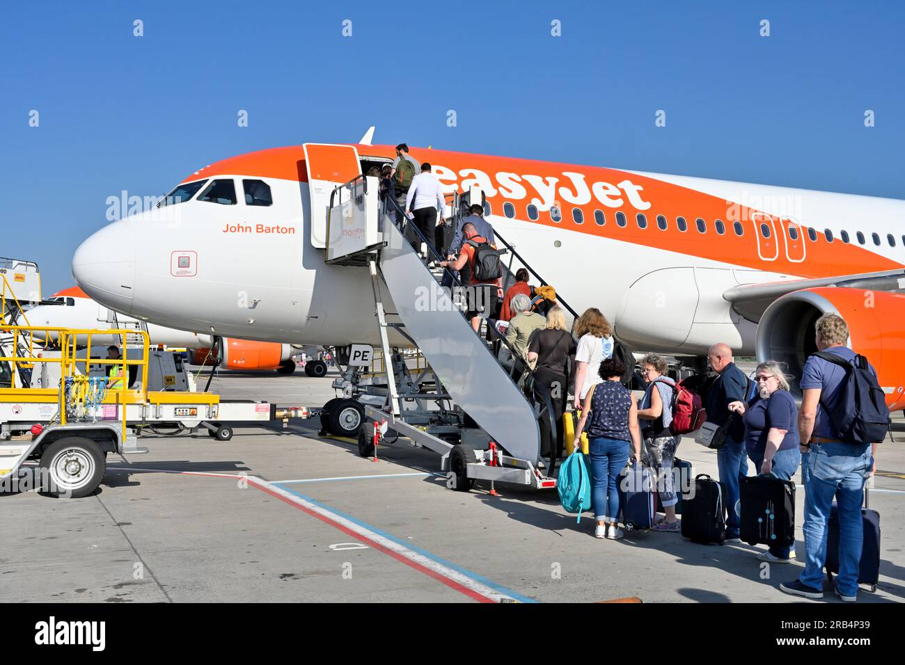 Passengers going up steps boarding EasyJet plane Stock Photo Alamy