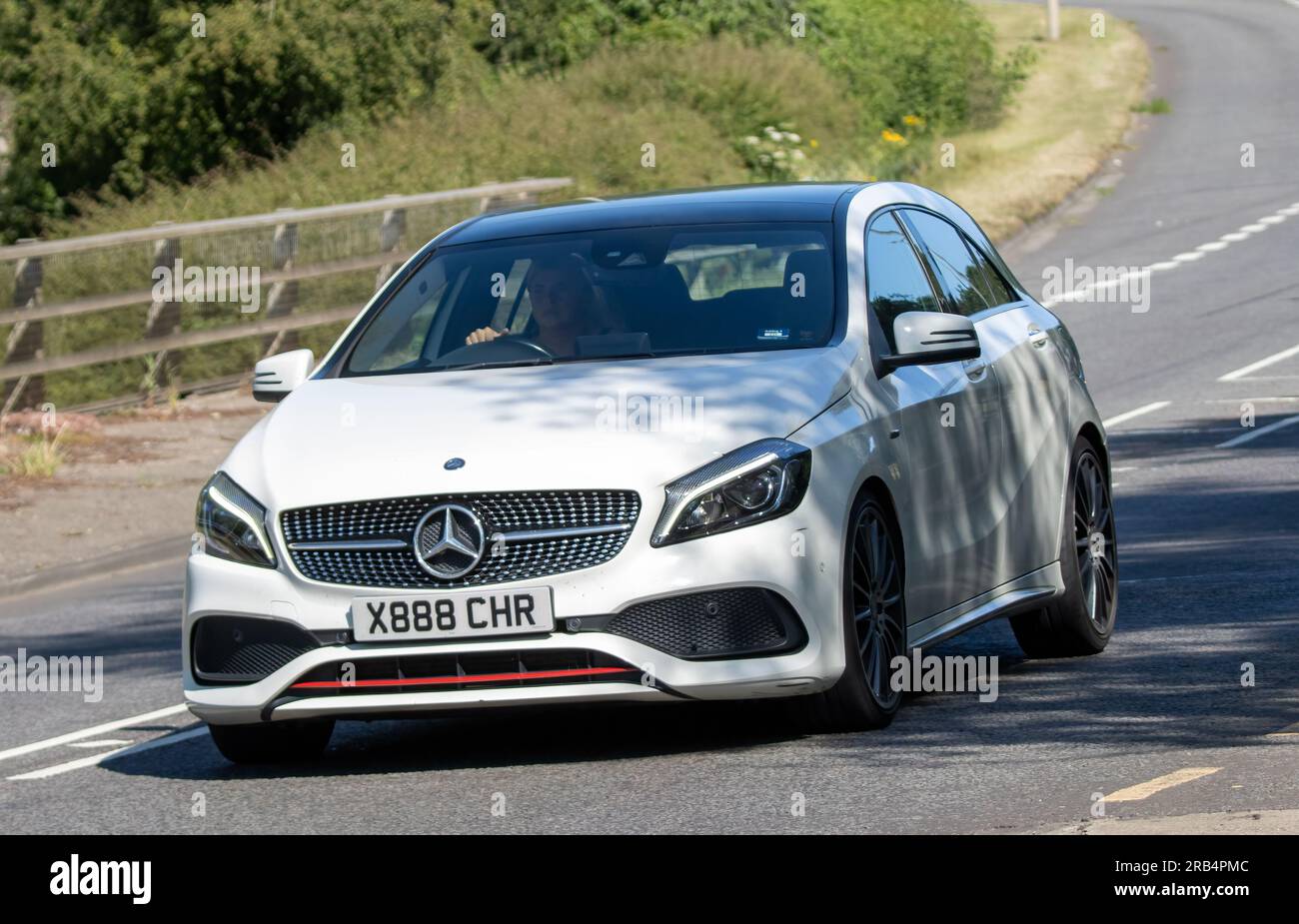 Milton Keynes,UK - July 7th 2023: 2016 white MERCEDES-BENZ A-CLASS A 250 AMG PREMIUM AUTO car travelling on a UK road Stock Photo