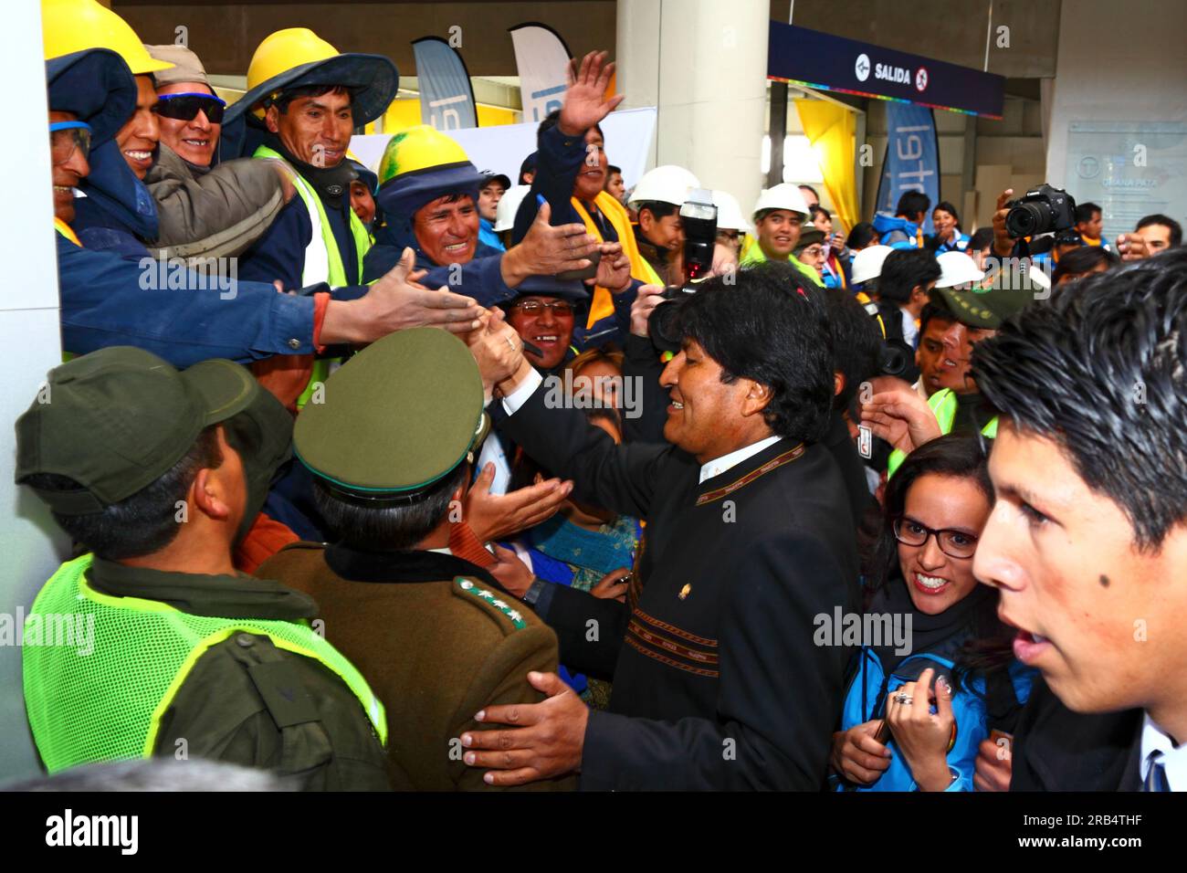 El Alto, Bolivia, 15th September 2014. Bolivian president Evo Morales (centre) greets Mi Teleferico company workers as he arrives at the station in Ciudad Satelite for the opening ceremony of the Yellow Line. The Yellow Line is the second of three cable car lines to be opened this year, and is part of an ambitious project to relieve traffic congestion. The first line opened in May, when all three are open they will be the world's longest urban cable car system. The system has been built by the Austrian company Doppelmayr. Stock Photo