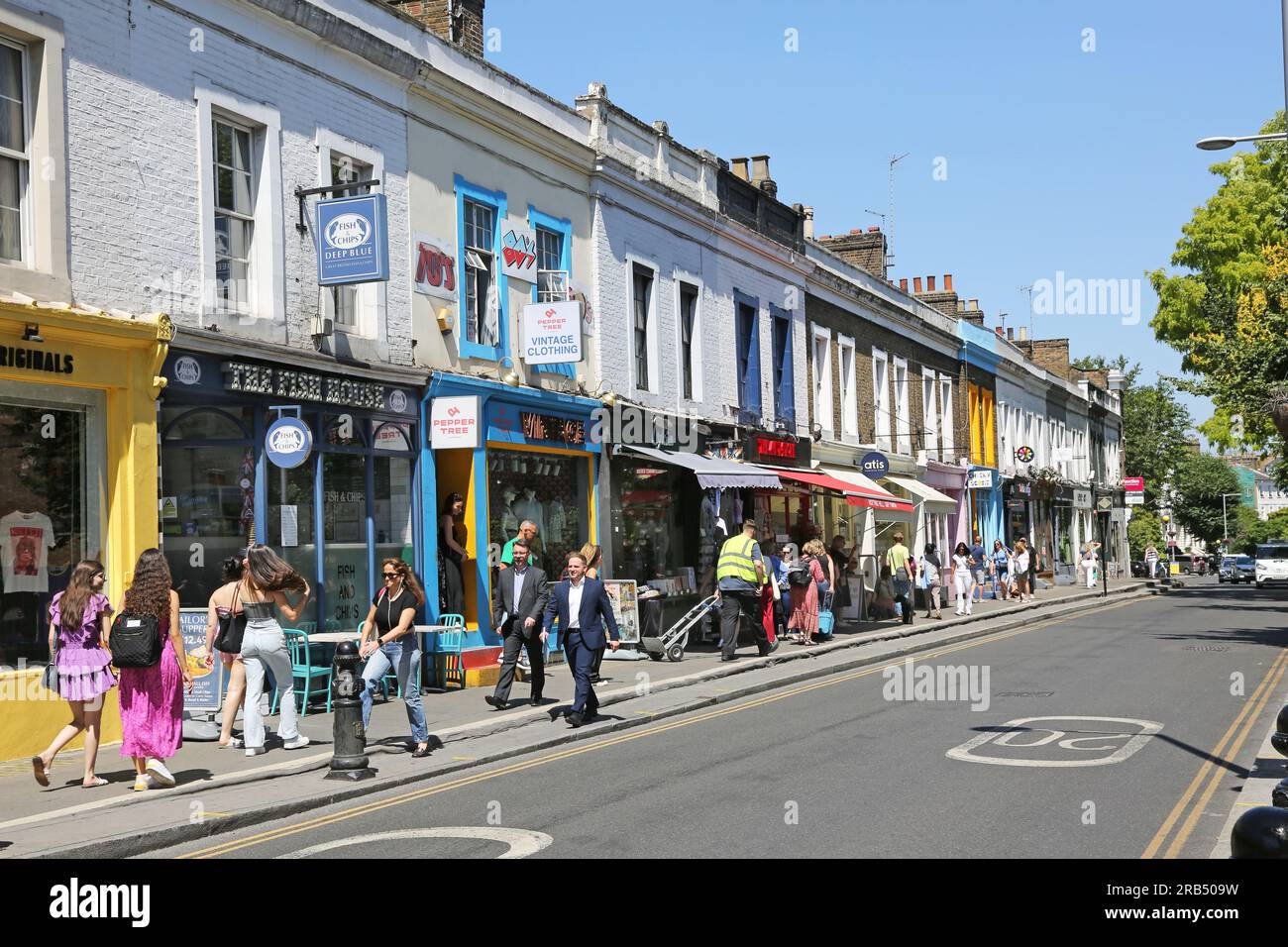London, UK: Shops and cafes on Pembridge Road, Notting Hill Gate, one of the the wealthiest areas of London. Busy with people on a hot, summer day. Stock Photo