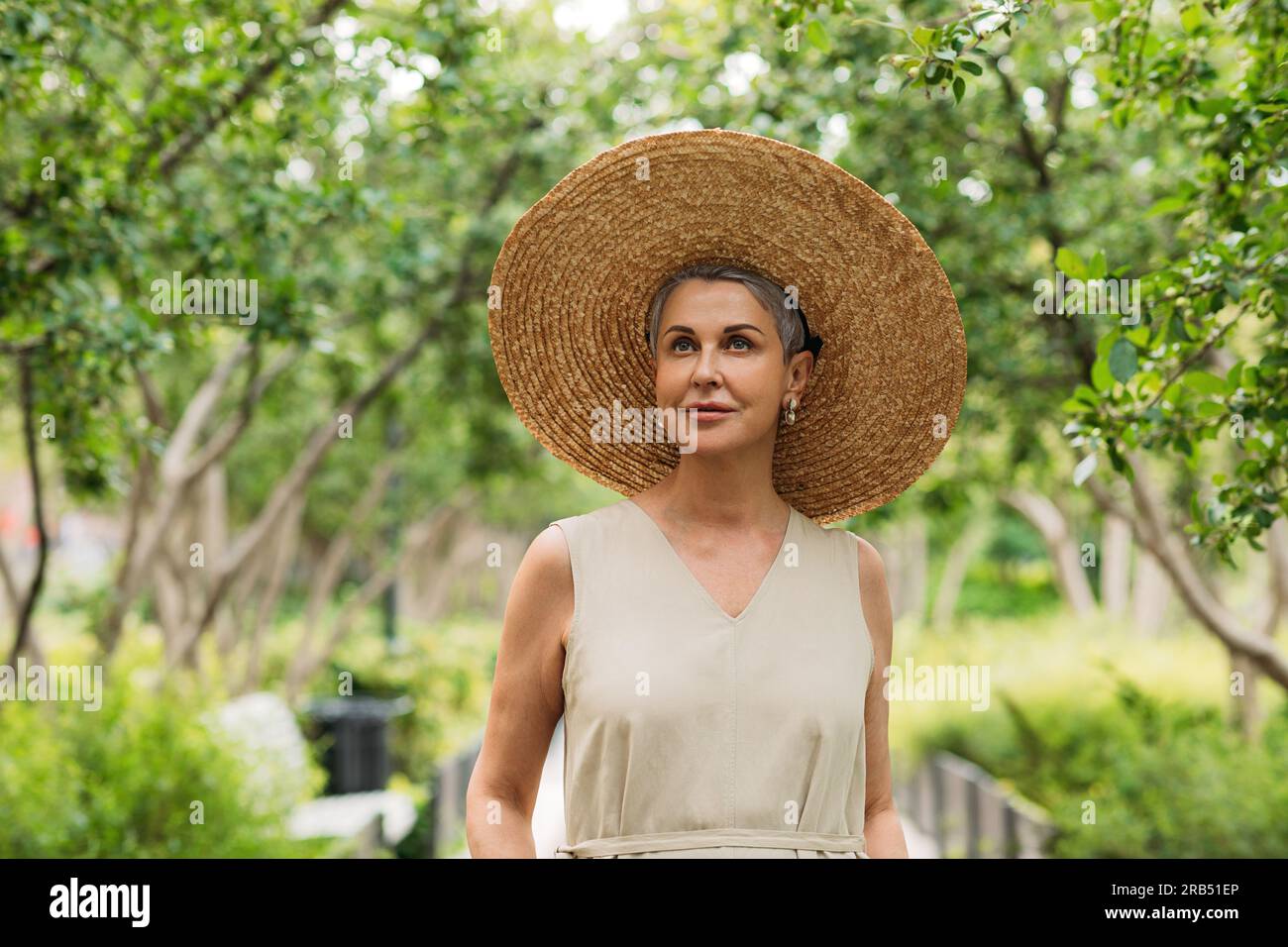 Senior woman walking in park hi-res stock photography and images - Alamy