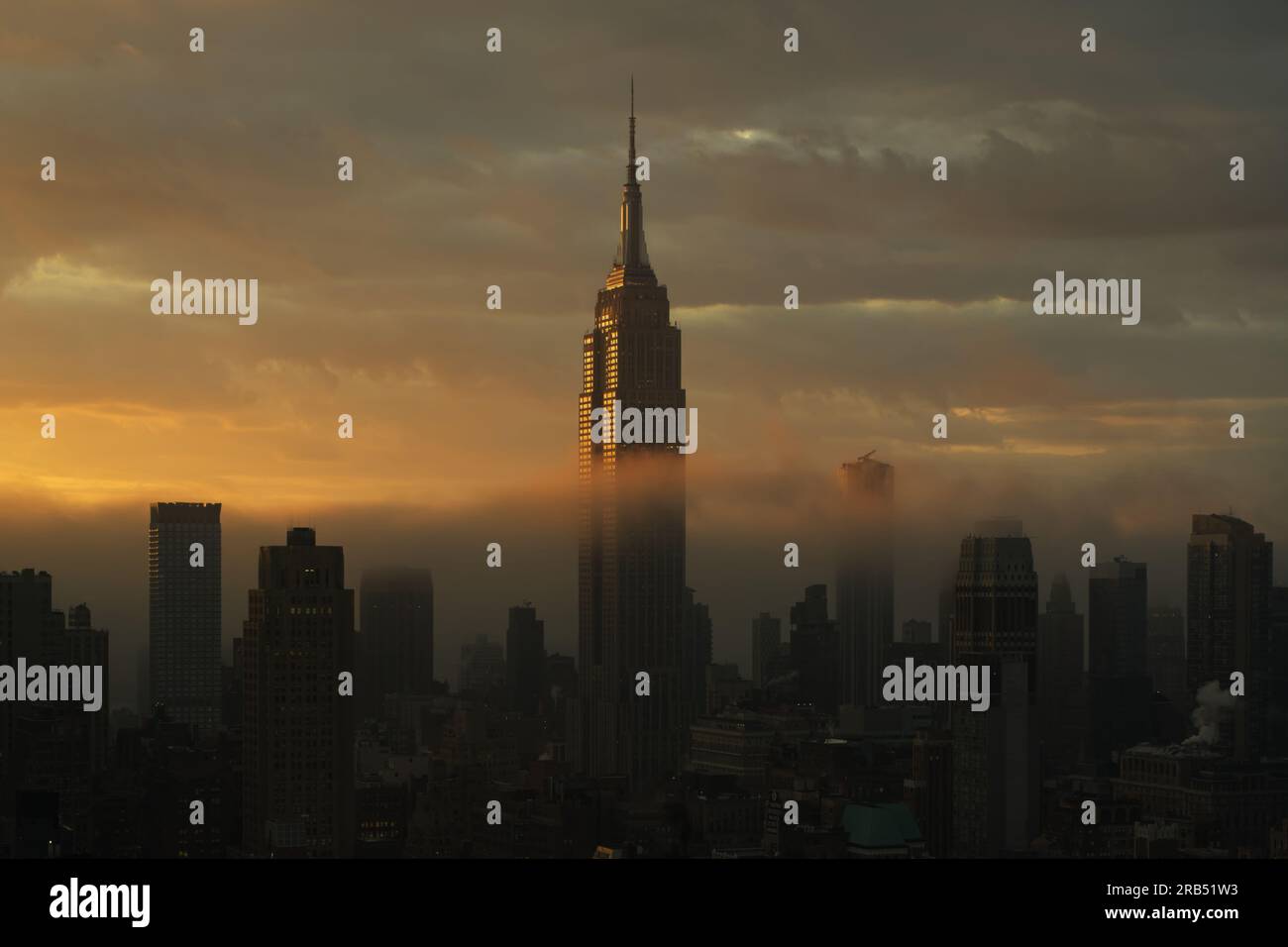 Empire State Building Lit by Rays of Sunrise Stock Photo - Alamy