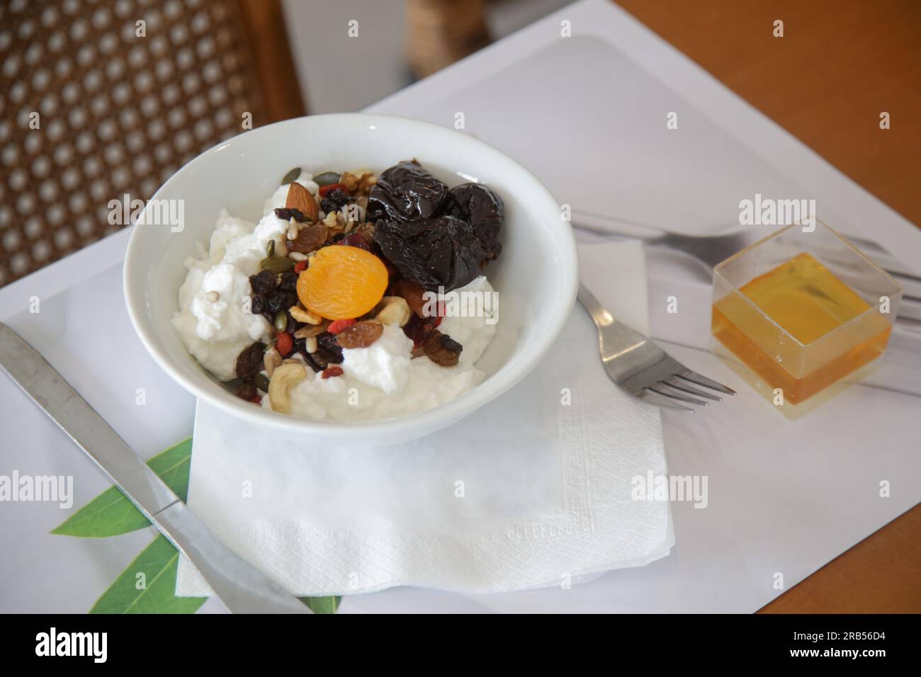 Greek yoghurt in bowl with honey, nuts, seeds and dried fruits, healthy