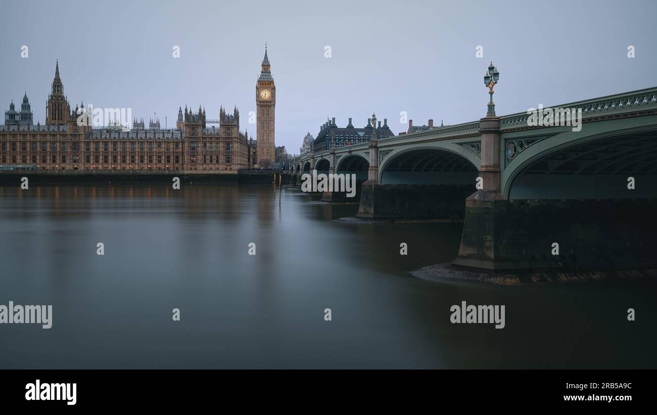 The Westminster Bridge and the Big Ben clocktower by the Thames river in London at dawn, United Kingdom Stock Photo