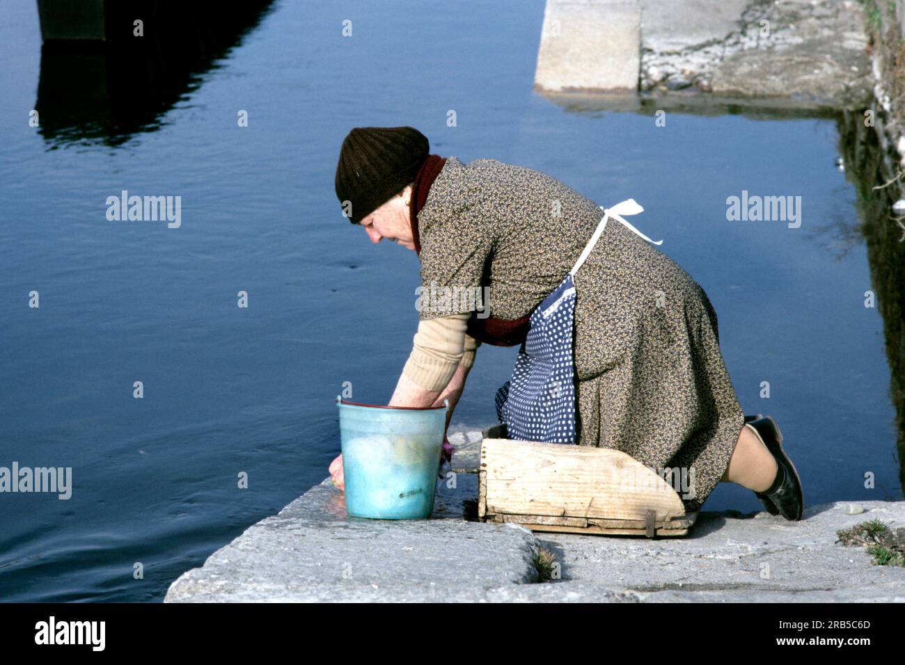 Elderly woman kneeling hi-res stock photography and images - Alamy