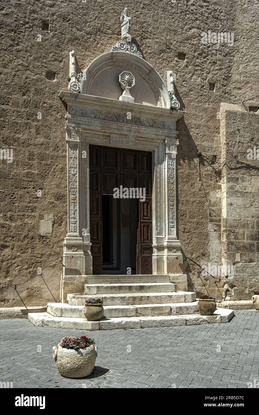 Stone portal from the 1400s with depictions of God and the sun on the facade of the church of San Domenico in Tocco da Casauria. Abuzzo Stock Photo