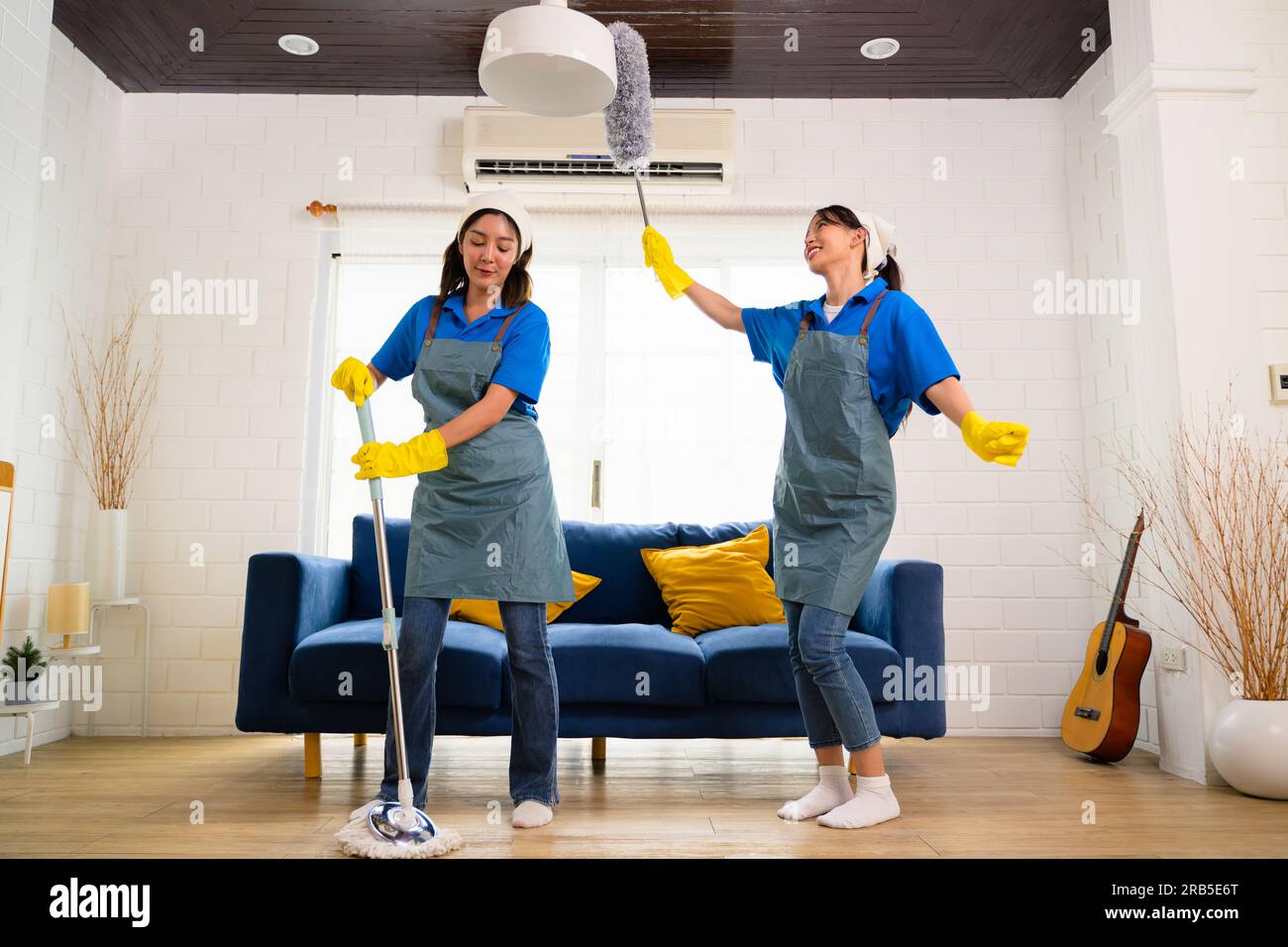 Couple of housekeeping staff cleaning house, Housekeeping and cleaning