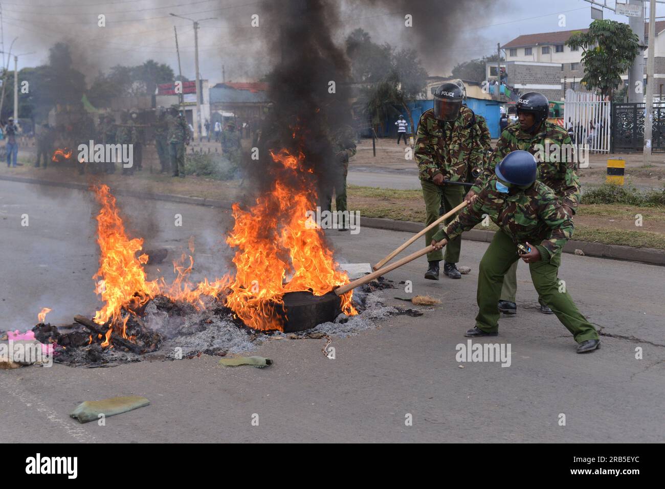 Nairobi, Kenya. 07th July, 2023. Anti-riot police officers remove burning tires that were lit by protesters during an anti-government protest dubbed 'Saba Saba' along Jogoo Road in Nairobi. Credit: SOPA Images Limited/Alamy Live News Stock Photo