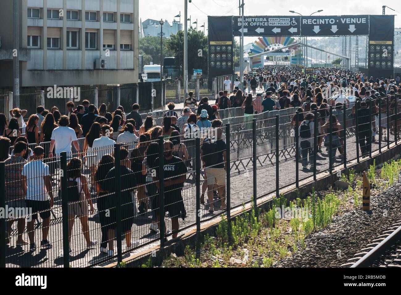 Lisbon, Portugal - July 7, 2023: Crowd of people walk towards NOS Alive, one of Europe s most respected indie, rock and alternative music festivals Stock Photo