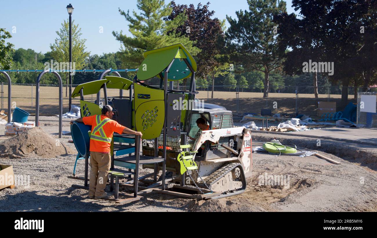 Toronto, Ontario / Canada - 08/19/2022: Using an excavator in the construction of a playground Stock Photo