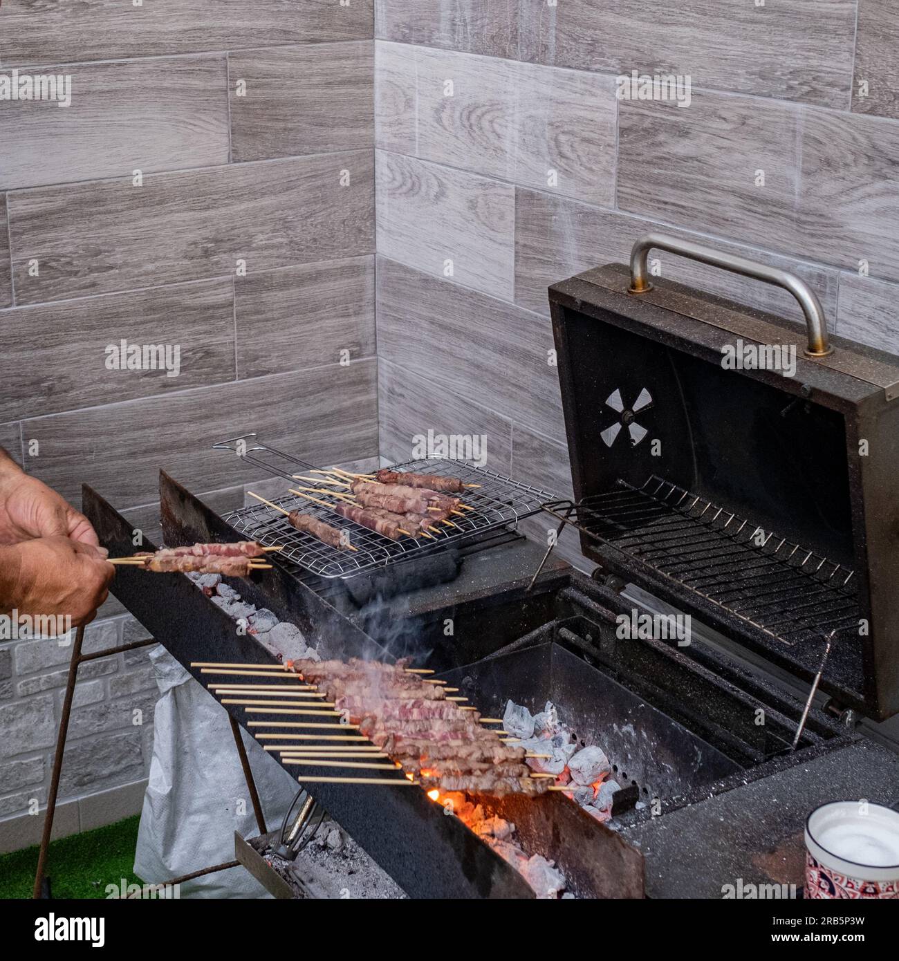 A characteristic setting for the preparation of 'arrosticini,' skewers of mutton meat, a traditional dish of regional cuisine in Abruzzo, Italy. Stock Photo