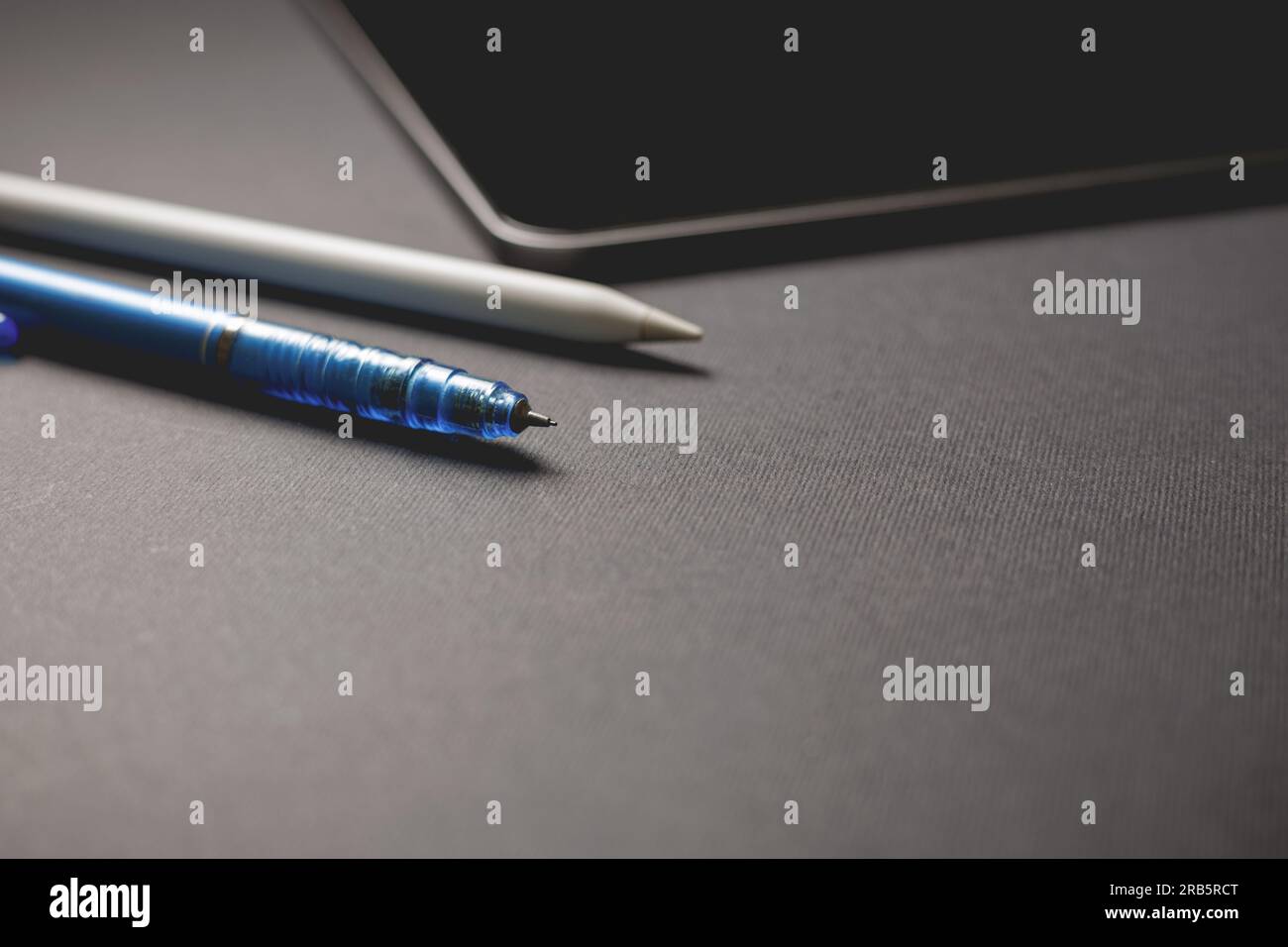 Pencil and tablet on black background. Close-up view. Stock Photo