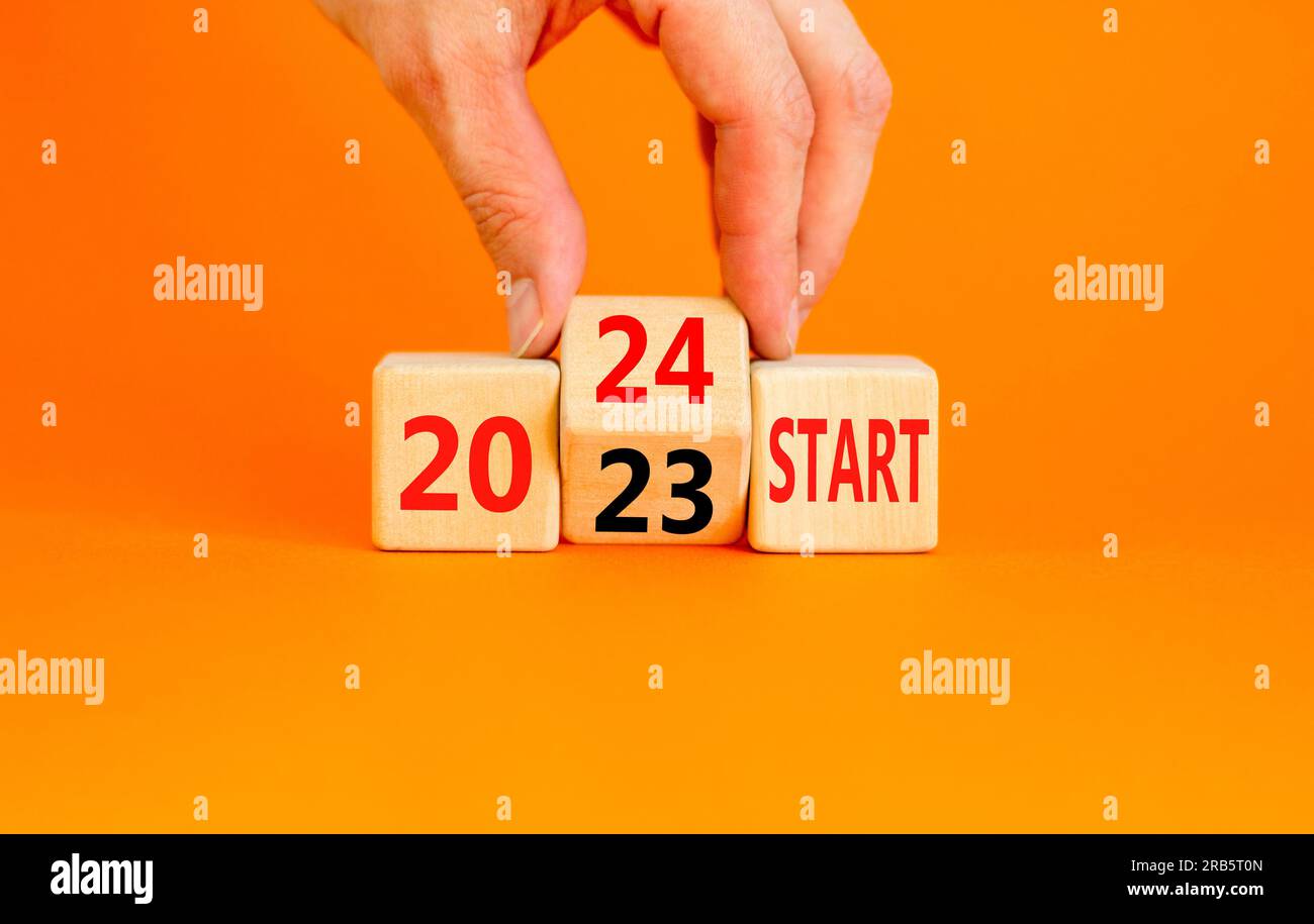 2025 start new year symbol. Businessman turns a wooden cube and changes