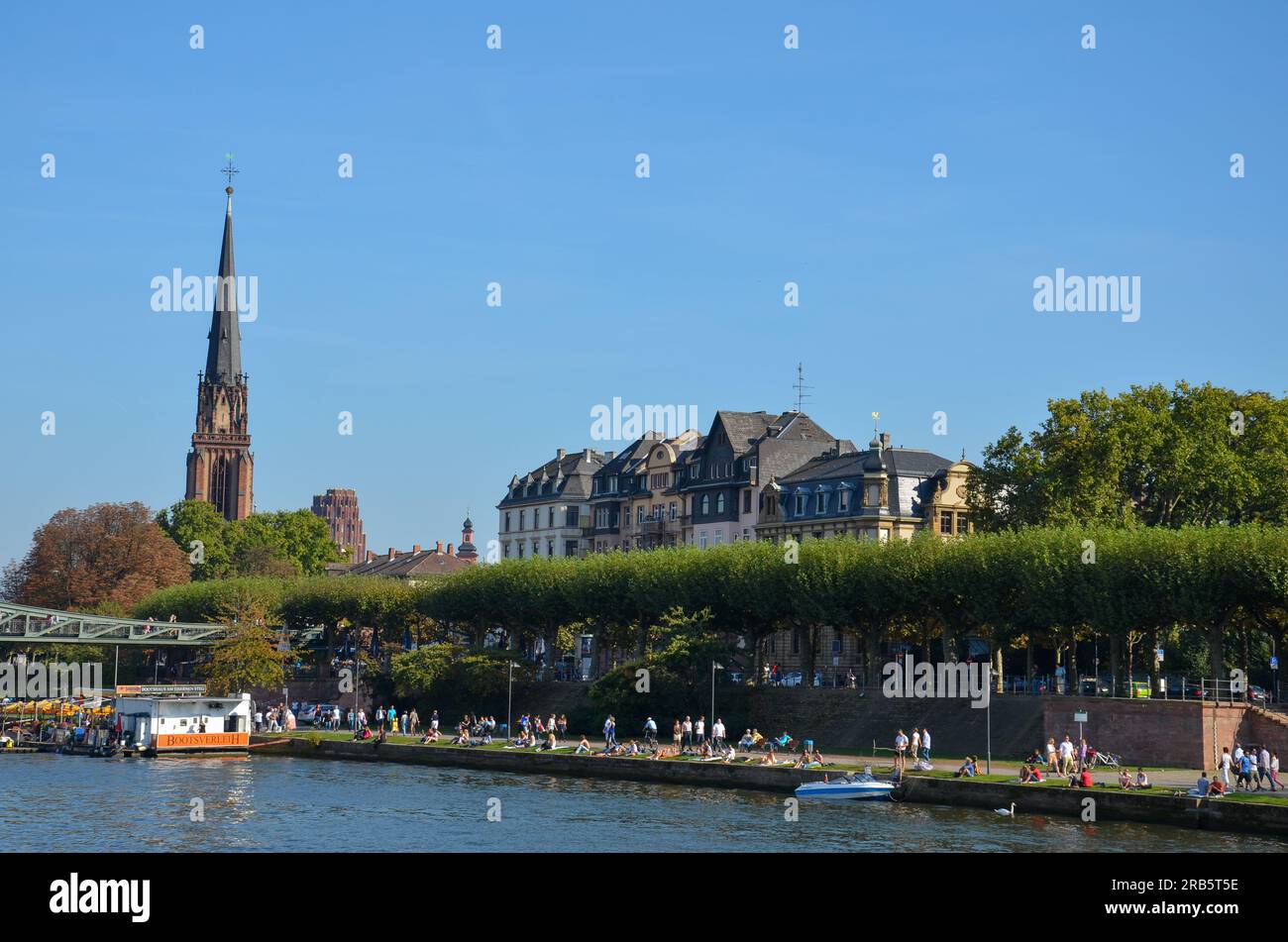 Frankfurt, Germany - October 3 2011: The Main riverbank in Frankfurt with the tower of the Dreikönigskirche in the background Stock Photo