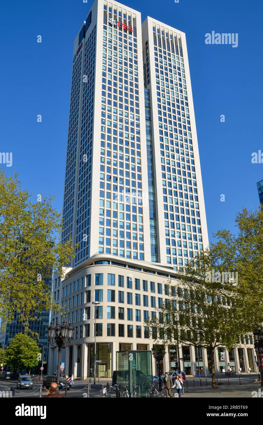 Frankfurt am Main, Germany: 19 April 2011: The Opernturm or UBS bank building in Frankfurt under blue sky with some trees in the foreground Stock Photo