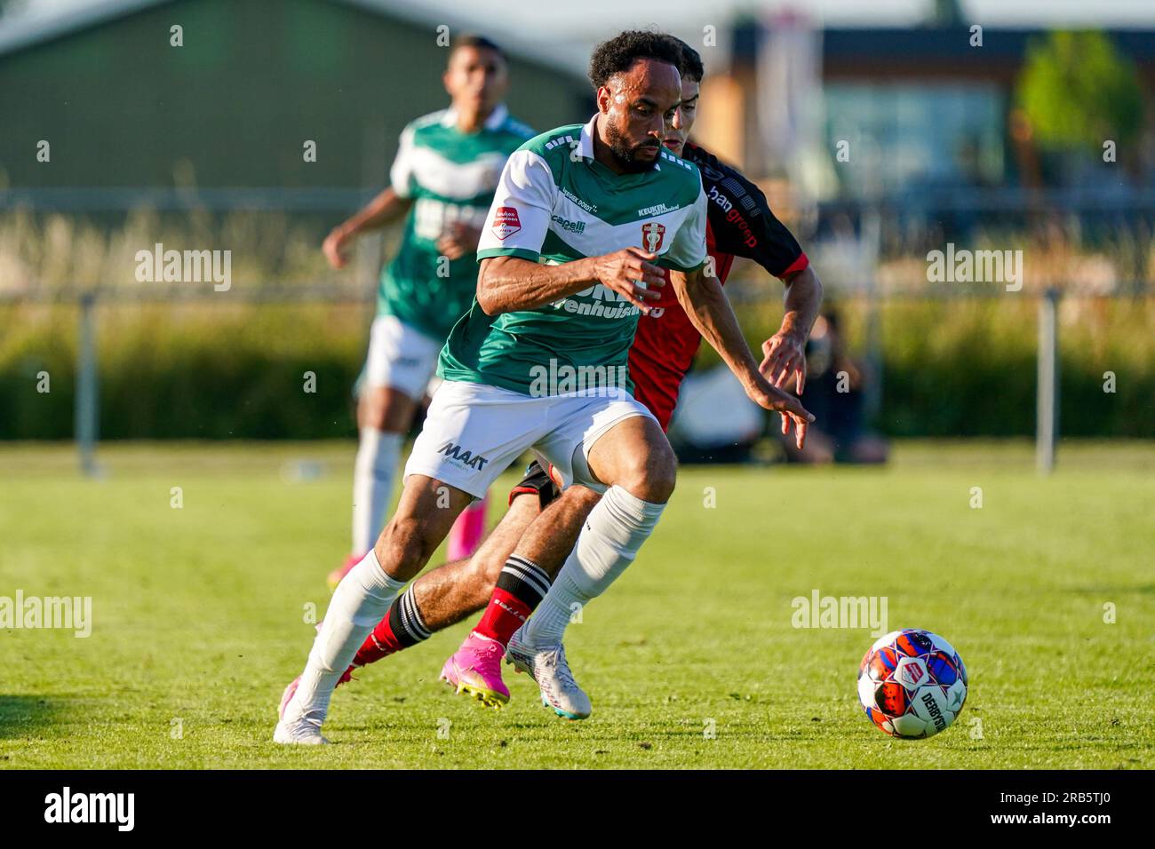 Maurik, Netherlands. 07th July, 2023. MAURIK, NETHERLANDS - JULY 7: Elso Brito of FC Dordrecht battle for possession with Florian Haxha of Helmond Sport during the Pre-Season Club Friendly Match match between FC Dordrecht and Helmond Sport at the Stadion TBC on July 7, 2023 in Maurik, Netherlands (Photo by Jeroen Meuwsen/Orange Pictures) Credit: Orange Pics BV/Alamy Live News Stock Photo