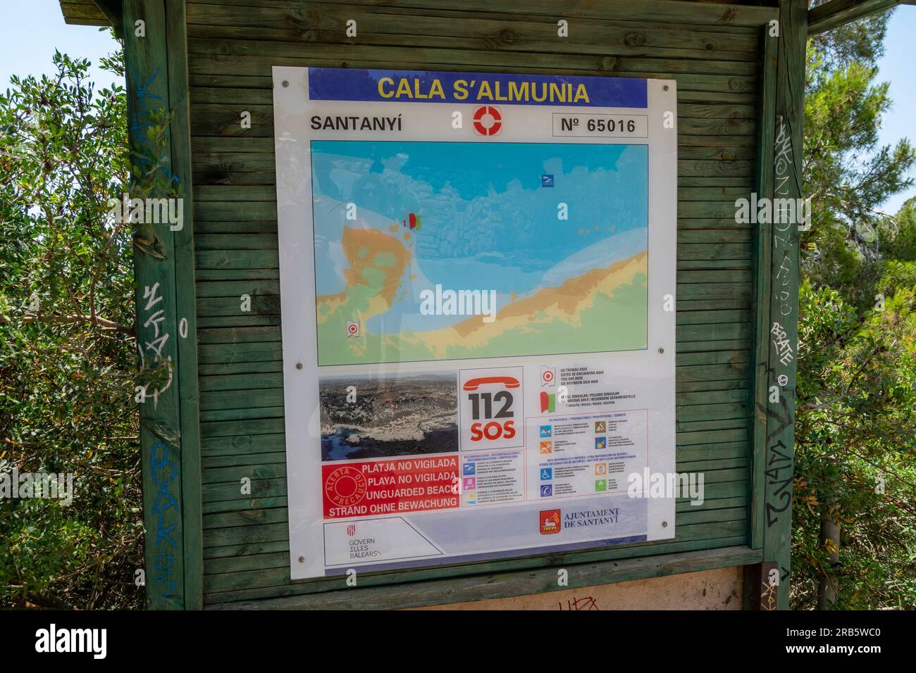 Palma de Mallorca cala S ´Almunia beach information panel for beach visitors. European emergency phone number. Stock Photo