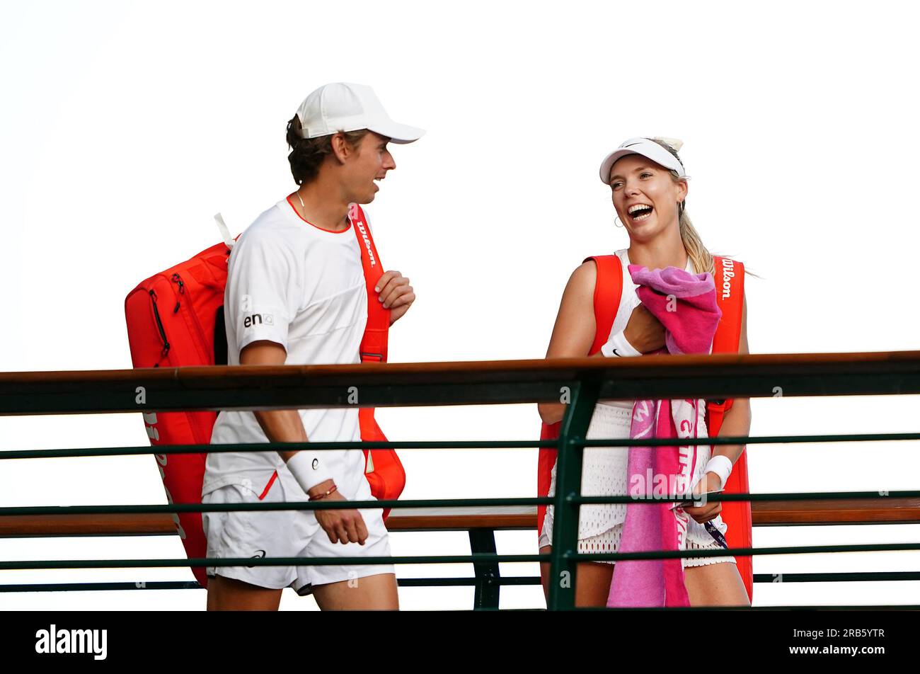 Katie Boulter and Alex De Minaur walk across a bridge after winning