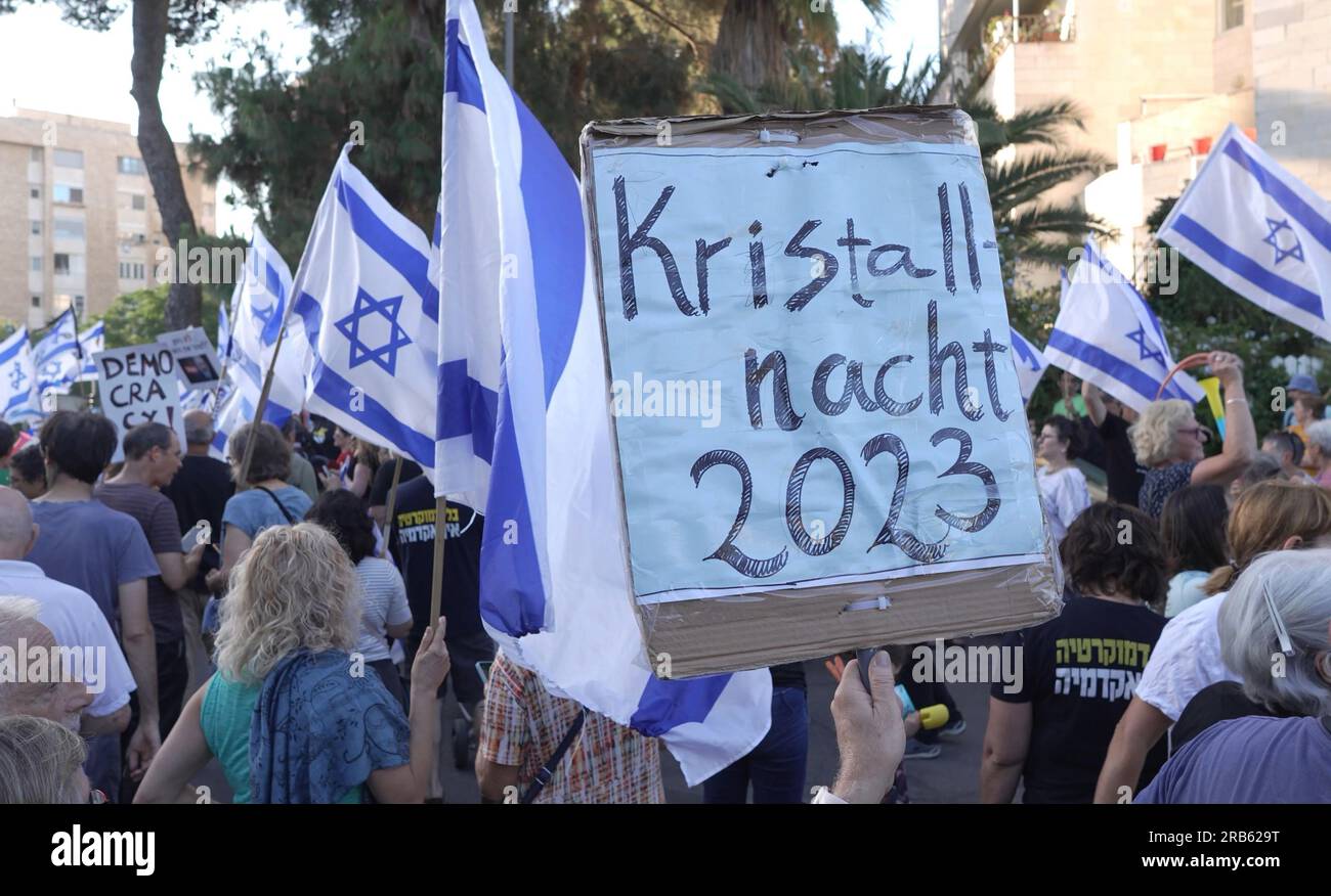 JERUSALEM, ISRAEL - JULY 6: A protester holds a sign which reads 'Kristall nacht 2023' (Referring to the Nazi Germany's 1938 pogroms against Jews also known as The Night of Broken Glass) during a protest held by anti-government protesters outside the private house of Economy Minister, Nir Barkat as part of nationwide protest outside ministers' homes in judicial reform protests on July 6, 2023 in Jerusalem, Israel. Stock Photo