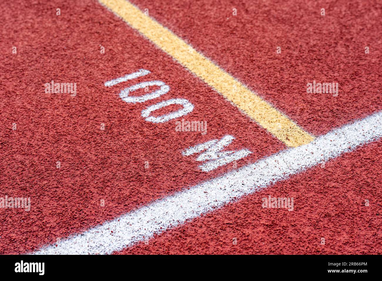 Close up of new red running track with 100 M text Stock Photo