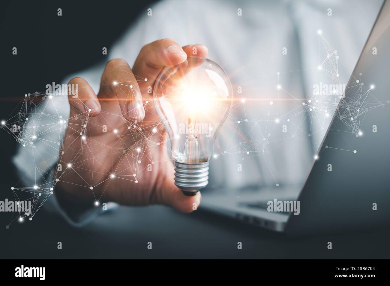 Businessman protects a glowing light bulb, symbolizing creativity and ...