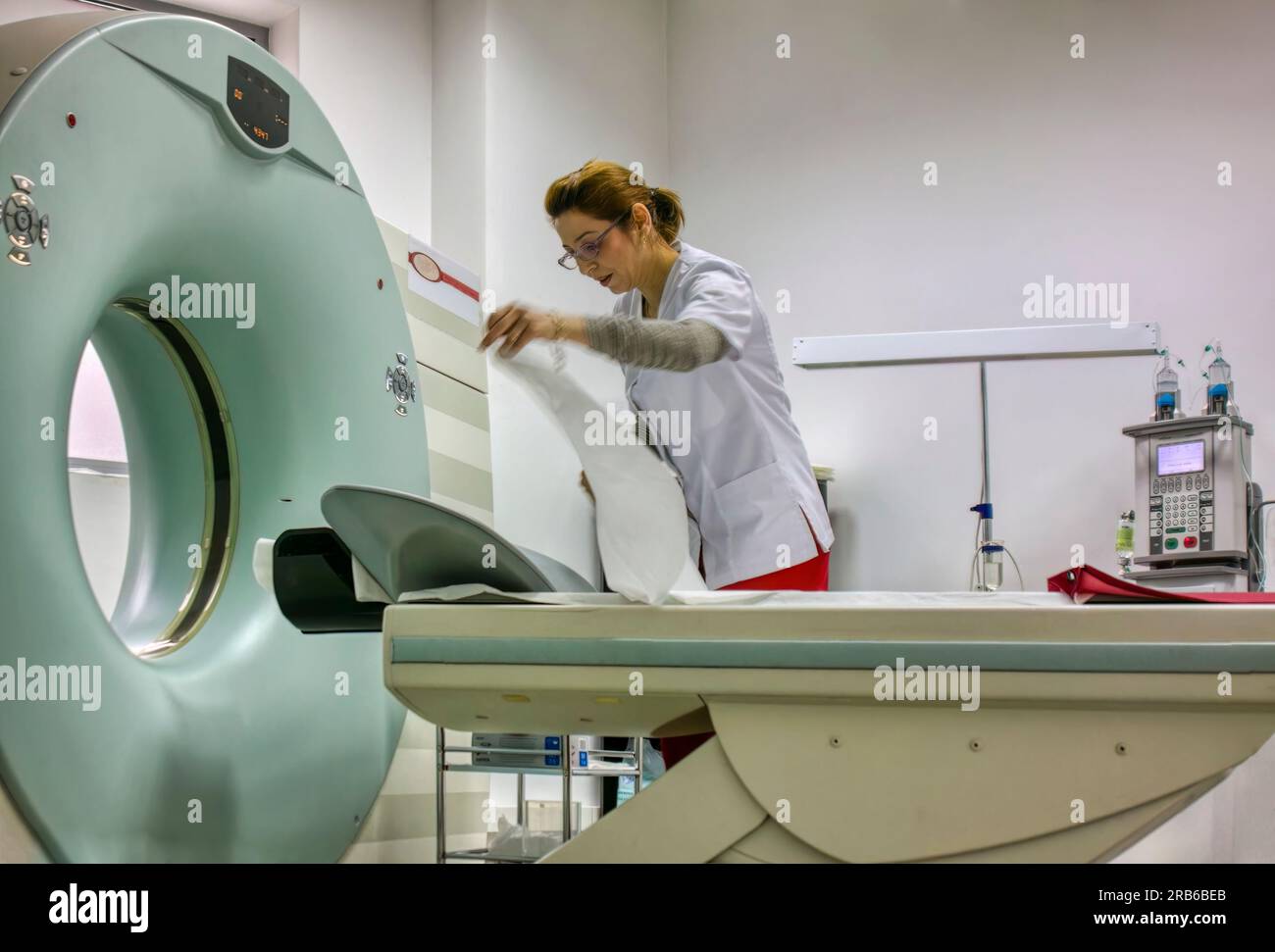 nurse arranging the MRI machine for the next patient to enter the hall Stock Photo