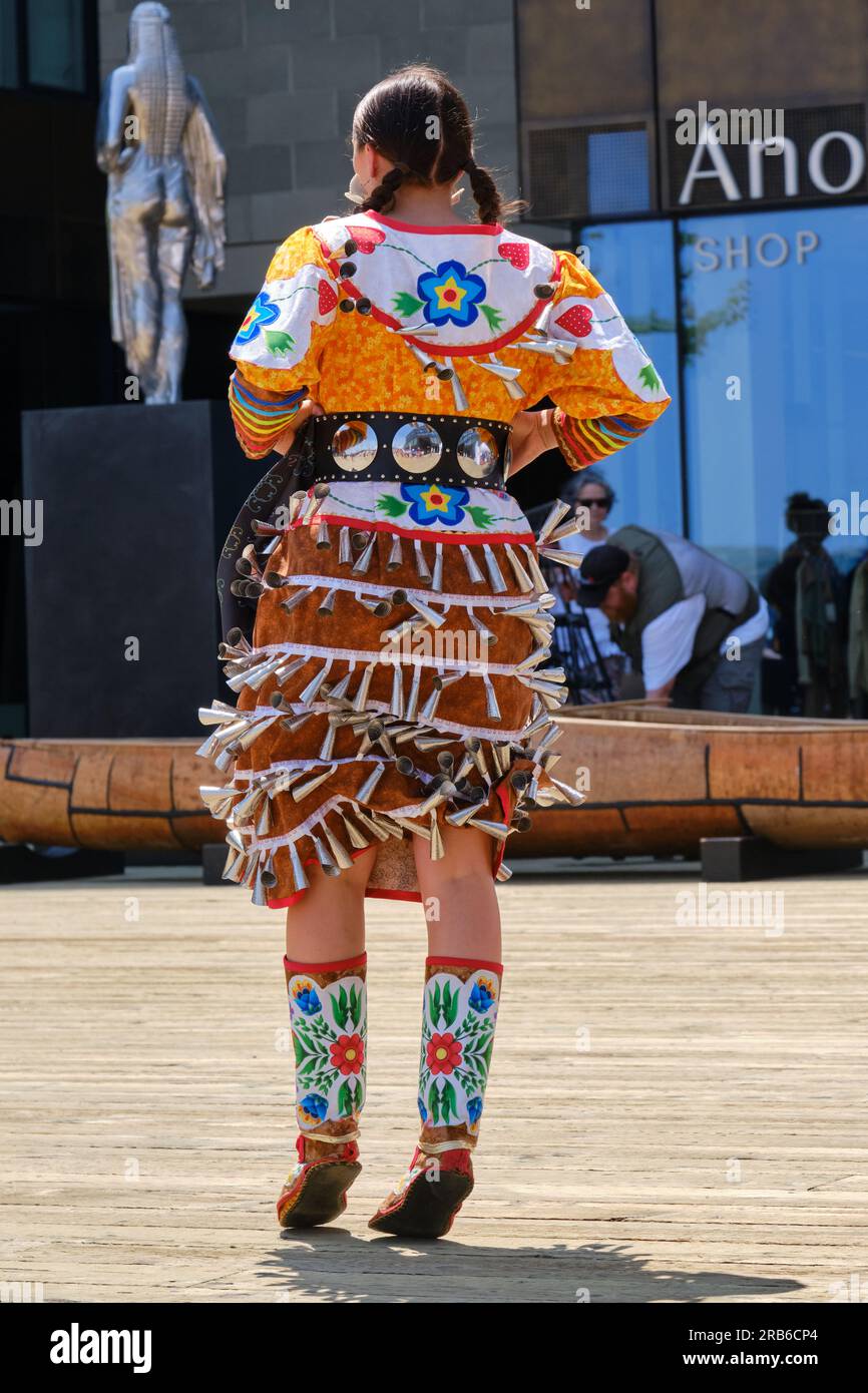Halifax, Canada. July 2023. Indigenous dancers in costumes from back performing a dance part of