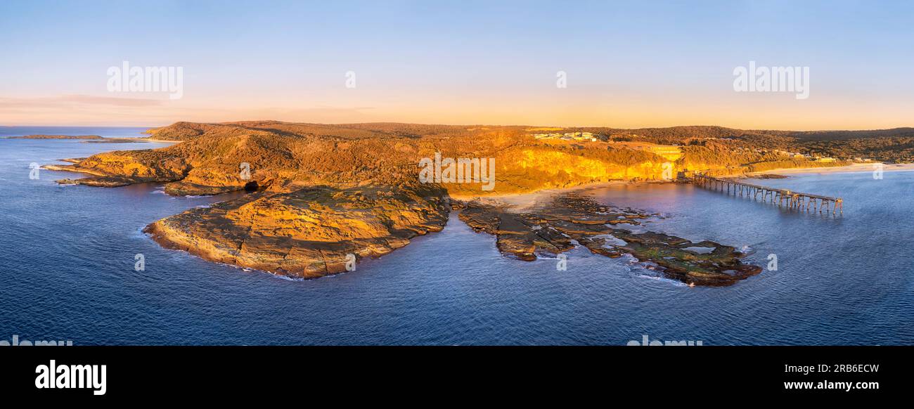 Close aerial view on sandstone rocky cape waterfront of Pacific ocean at Middle camp beach on Catherine Hill bay coast in Australia. Stock Photo
