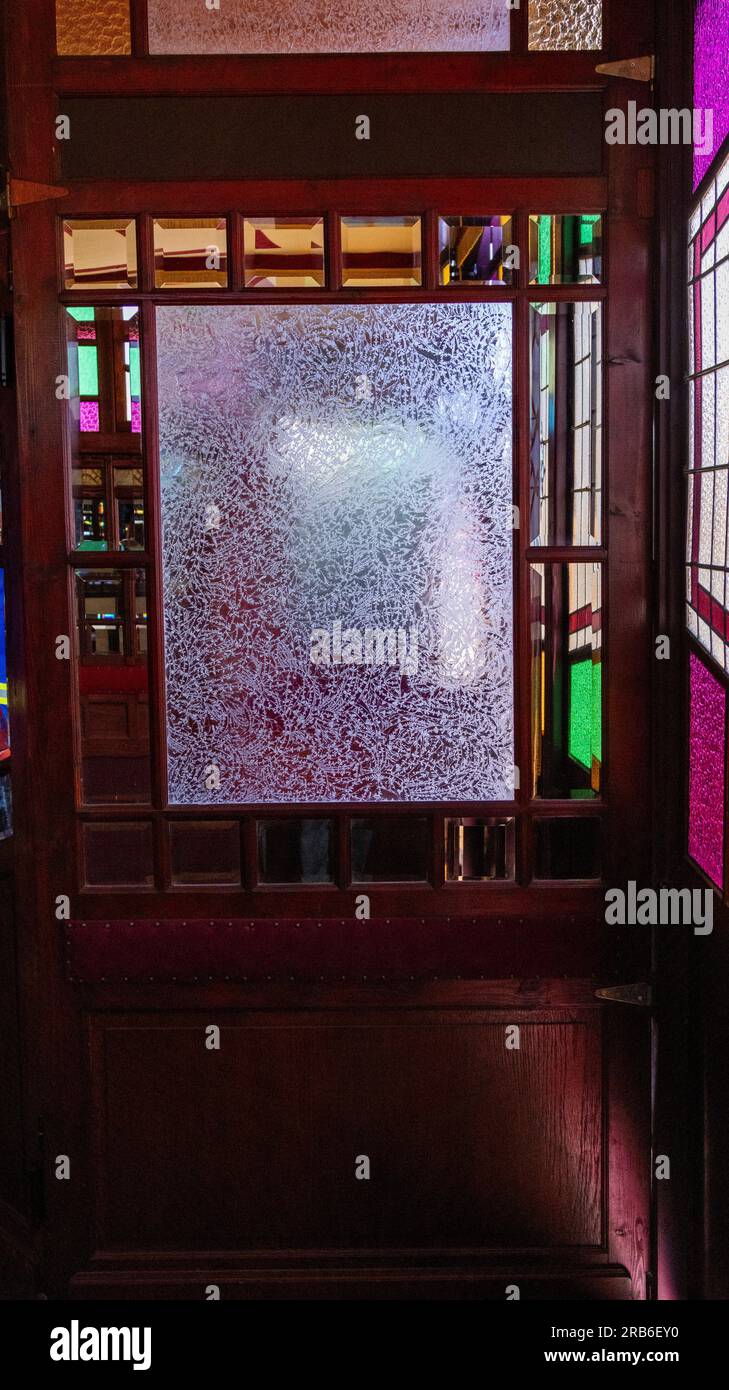 The inlay glass of the entrance to the Cristal Palace showcasing the wood and mirror surfaces of