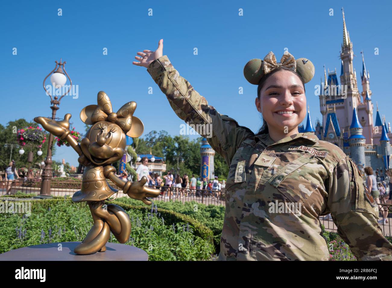 Orlando, United States. 04 July, 2023. U.S. Air Force Senior Airman Leandra Garcia, 33rd Fighter Wing public affairs specialist, poses next to a statue of Minnie Mouse during a flyover by their teams at Disney World, July 4, 2023 in Orlando, Florida, July 4, 2023. The flyover celebrated Independence Day and the 100th anniversary of Walt Disney Company.    Credit: SrA Joshua Hastings/U.S. Air Force/Alamy Live News Stock Photo