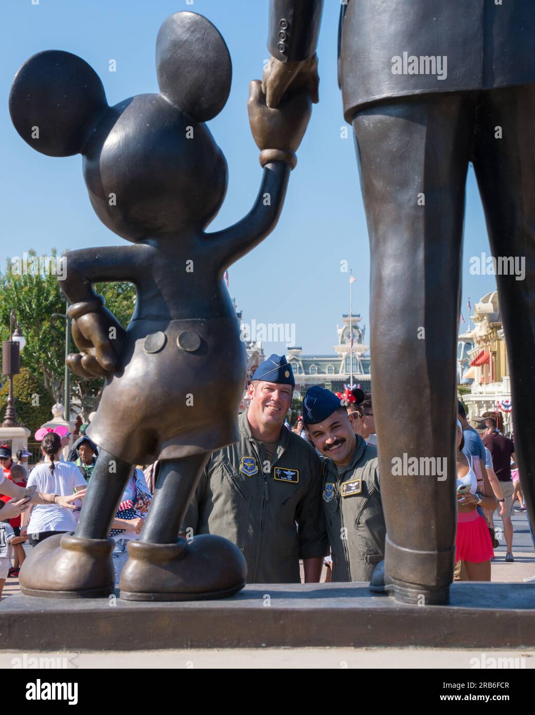 Orlando, United States. 04 July, 2023. U.S. Air Force Maj. Clark Hall, 91st Air Refueling Squadron pilot, left, and Staff Sgt. Juan Ramirez Ceballos, 91st ARS boom operator, look at the Mickey Mouse and Walt Disney statue during a flyover by their teams at Disney World, July 4, 2023 in Orlando, Florida, July 4, 2023. The flyover celebrated Independence Day and the 100th anniversary of Walt Disney Company.    Credit: SrA Joshua Hastings/U.S. Air Force/Alamy Live News Stock Photo