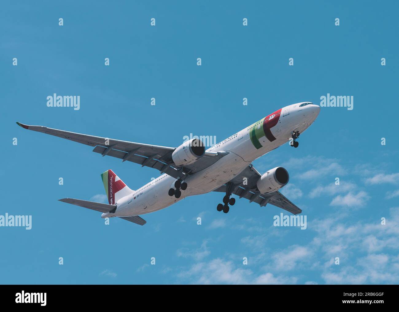 Lisbon, Portugal - July 6, 2023: View of a TAP Air Portugal Airbus A321 jet airplane approaching to land with blue sky background Stock Photo