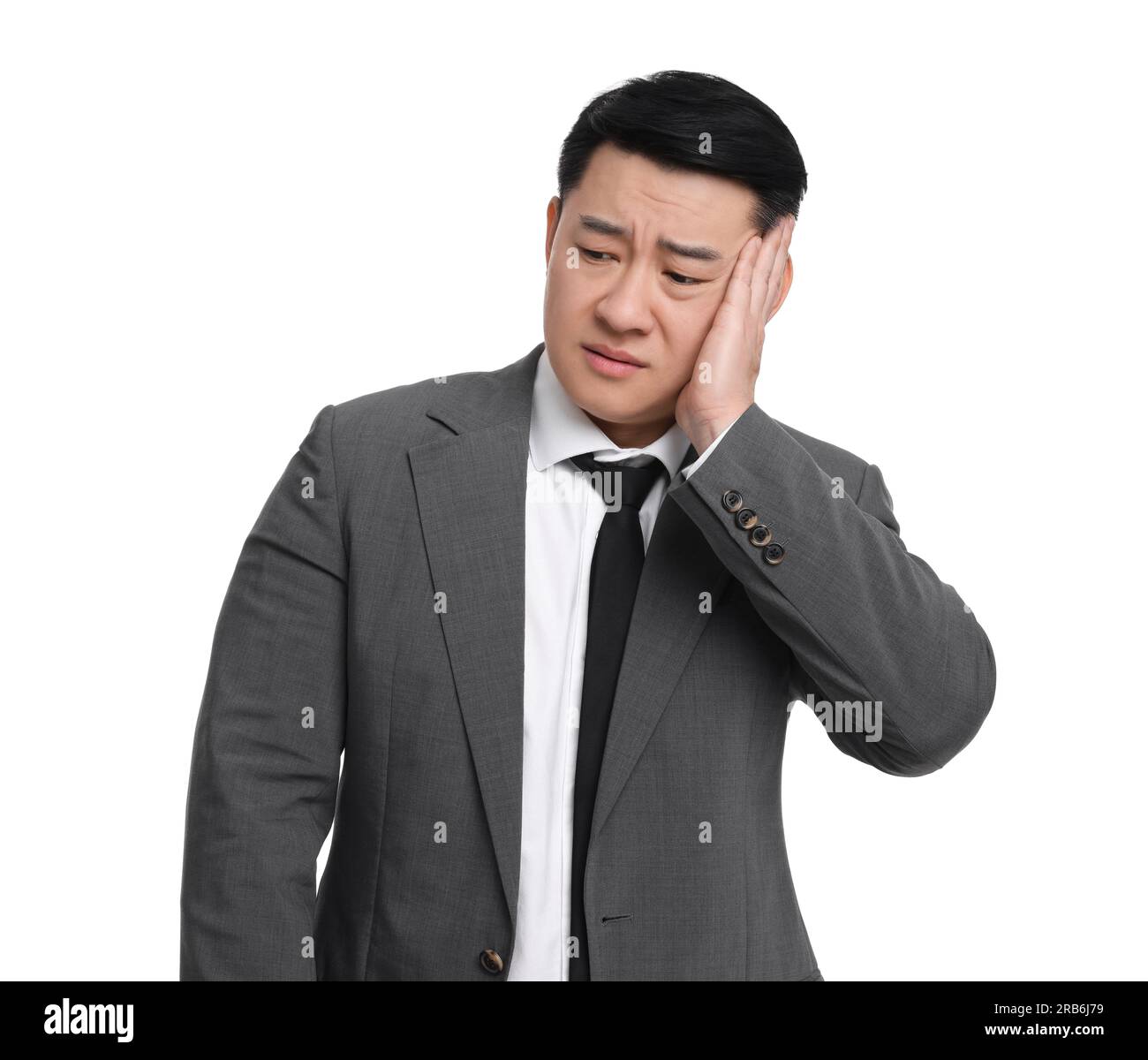 Tired businessman in suit posing on white background Stock Photo