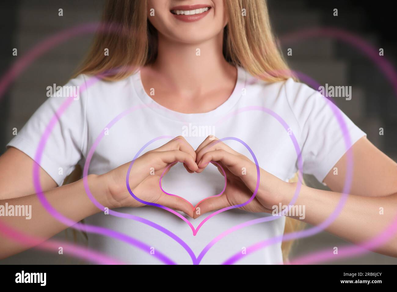 Empathy. Smiling woman sharing positive vibes, closeup. Concentric hearts flying out of her hands as symbol of support Stock Photo