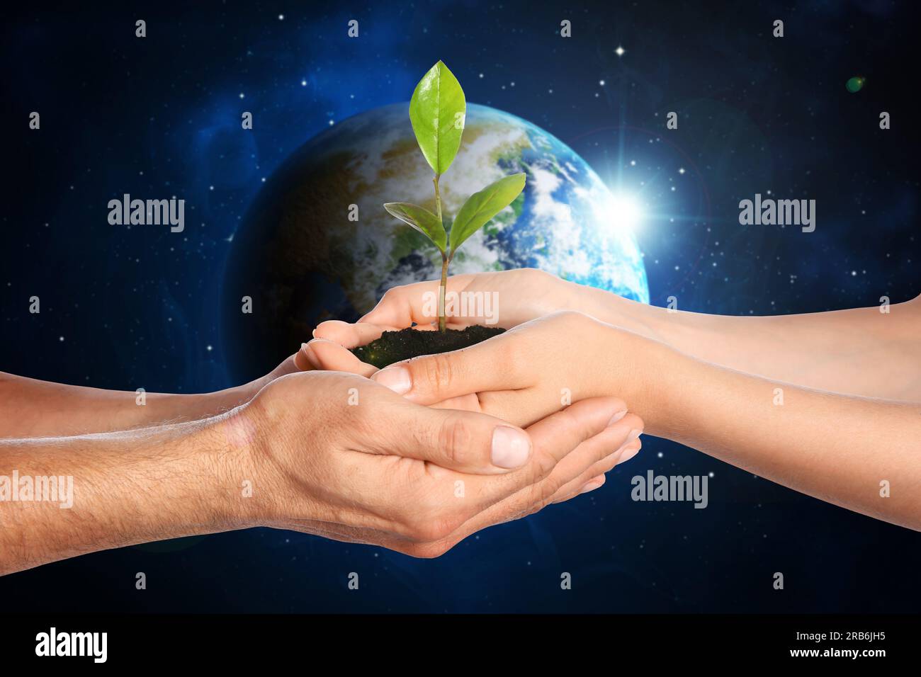 Make Earth green. Woman and man holding soil with green seedling in hands, closeup. Globe in space on background Stock Photo