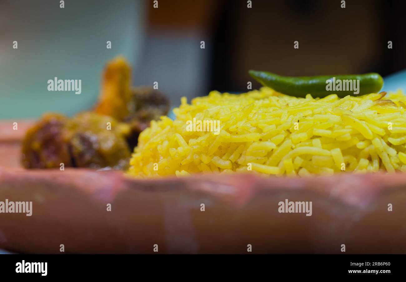 Pulav and mutton curry served on a plate. Traditional Bengali basanti polao or misti polao or fried rice served with mutton gravy dish on Durga navami Stock Photo