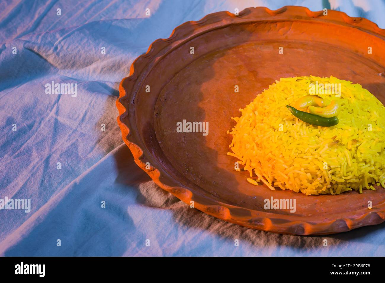Pulav served on a clay plate. Traditional Bengali basanti polao or sweet polao or fried rice served as offering to the deity. Stock Photo