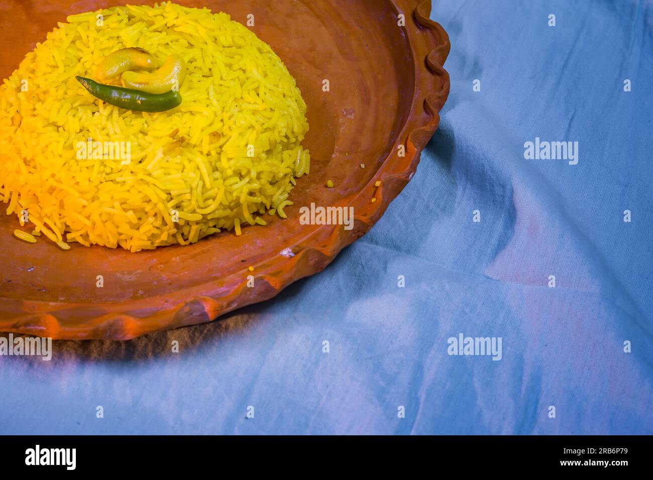 Pulav served on a clay plate. Traditional Bengali basanti polao or sweet polao or fried rice served as offering to the deity. Stock Photo