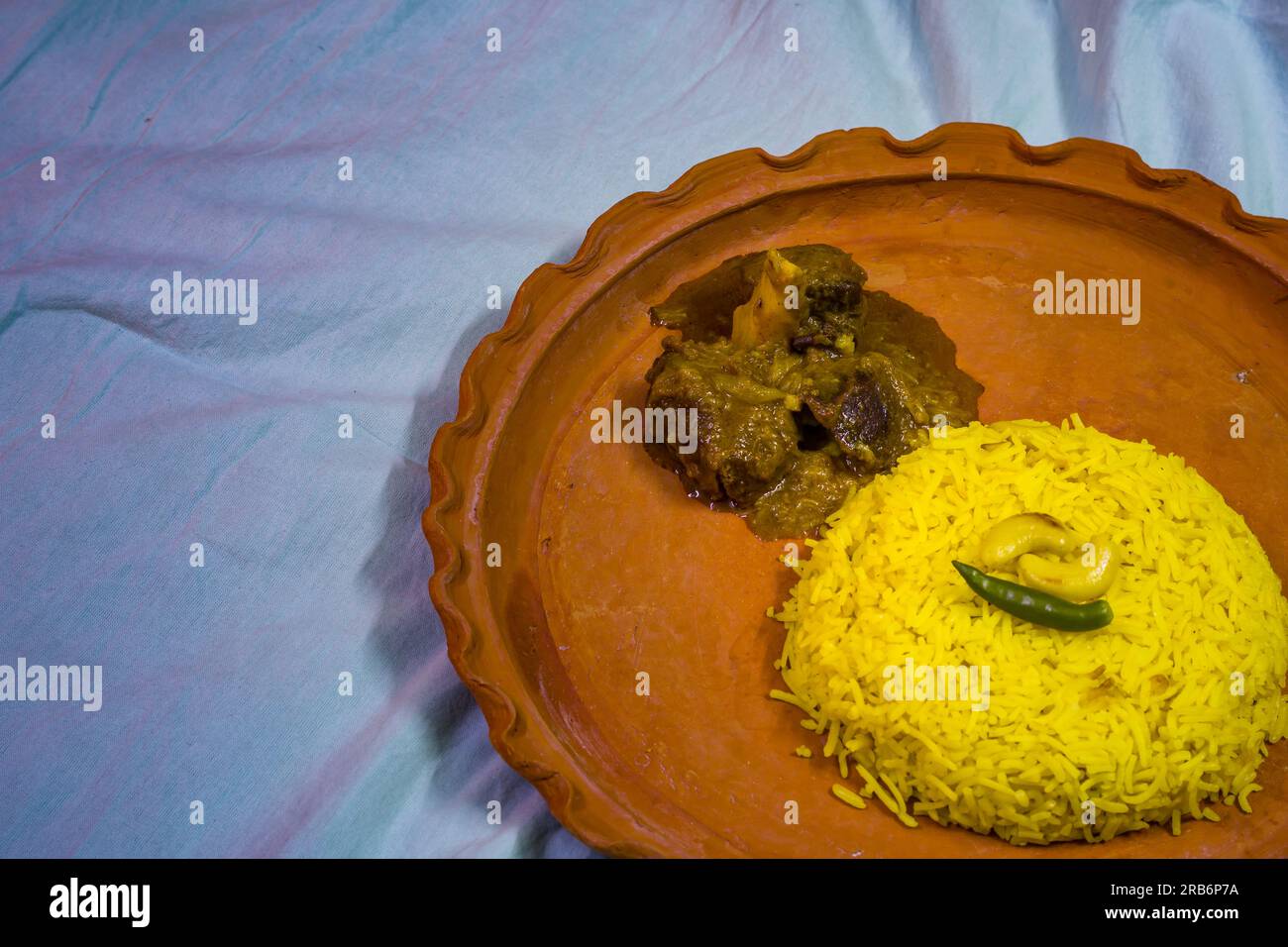 Pulav and mutton curry served on a plate. Traditional Bengali basanti polao or misti polao or fried rice served with mutton gravy dish on Durga navami Stock Photo