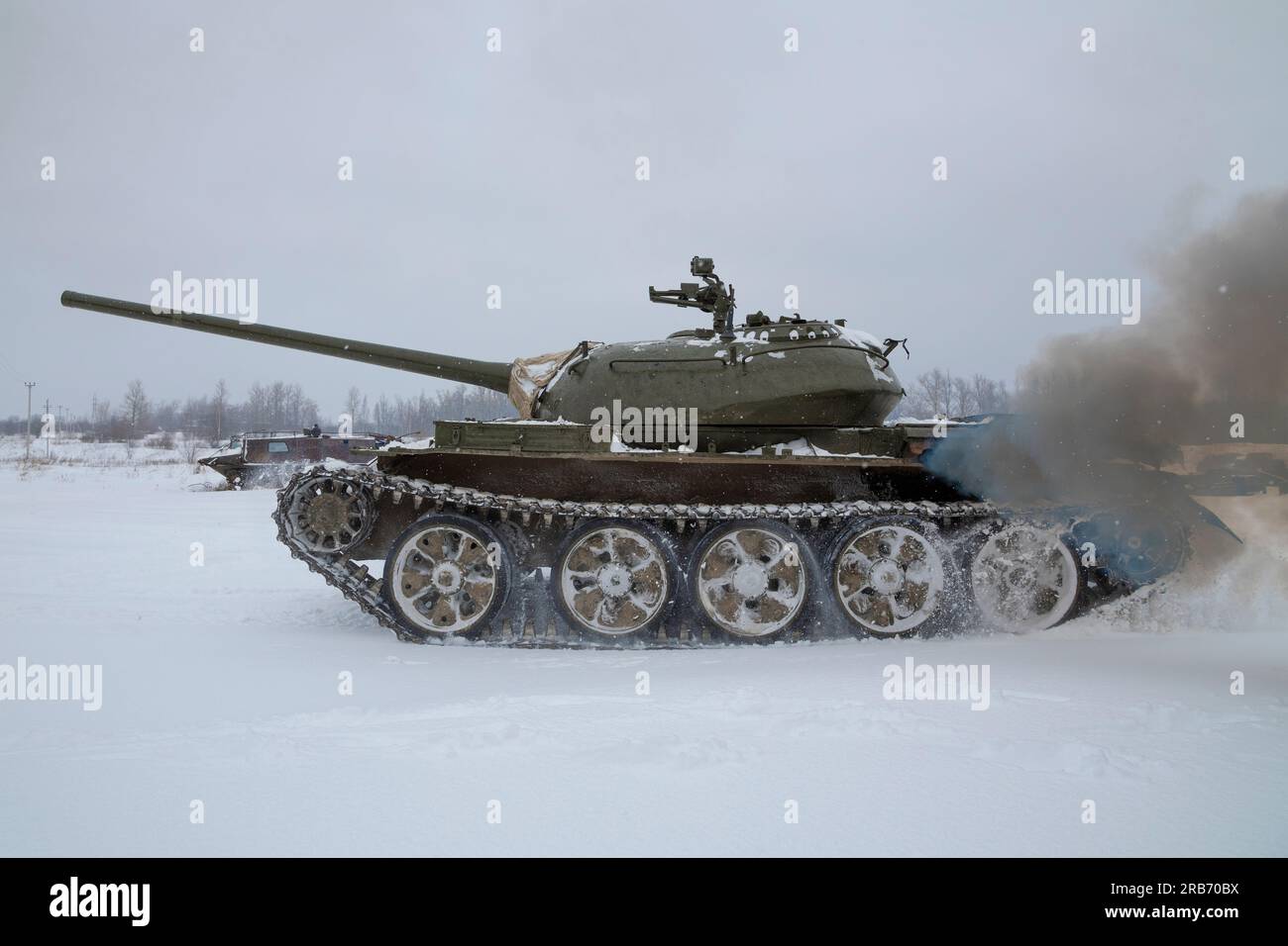 KRASNOYE SELO, RUSSIA - FEBRUARY 19, 2023:  Soviet tank T-54 on the move on a gloomy winter day. Fragment of a tank show in the military historical pa Stock Photo