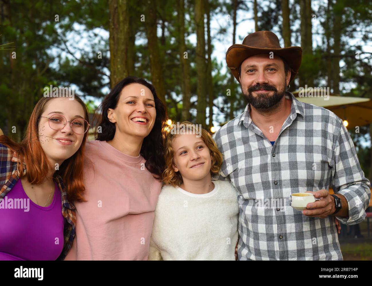 Family members father, mother and two daughters laughing in camping in ...