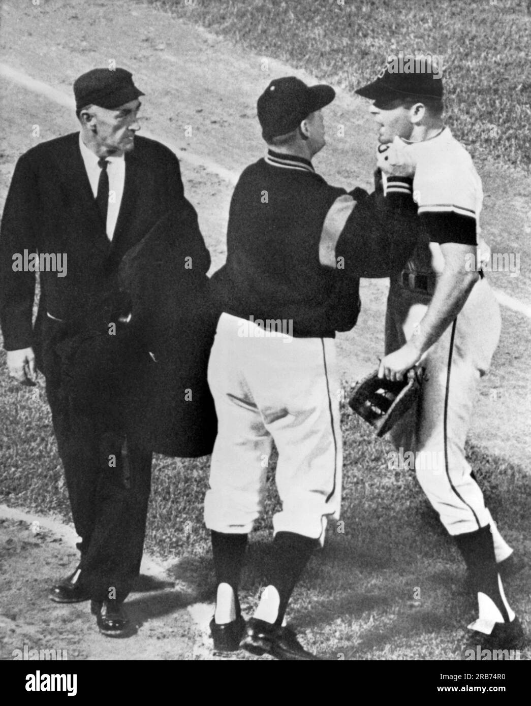 Baltimore, Maryland:  May, 1963 Baltimore first baseman JIm Gentile gets collared by his manager Billy Hitchcock as he charged towards umpire Ed Runge after being ejected from the game. Stock Photo